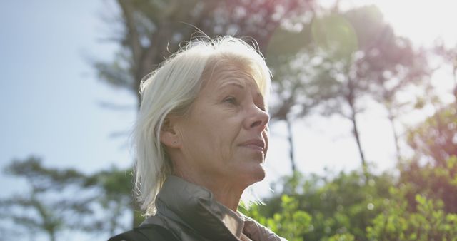 Senior Woman Reflecting Outdoors with Sun Flare - Download Free Stock Images Pikwizard.com