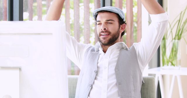 Casual Young Man Relaxing with Arms Stretched in Bright Space - Download Free Stock Images Pikwizard.com