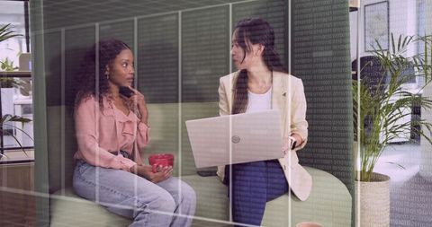 Businesswomen Collaborating in Modern Office Space with Laptop