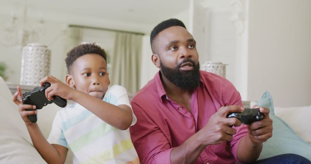 African American Father and Son Playing Video Games Together at Home - Download Free Stock Images Pikwizard.com