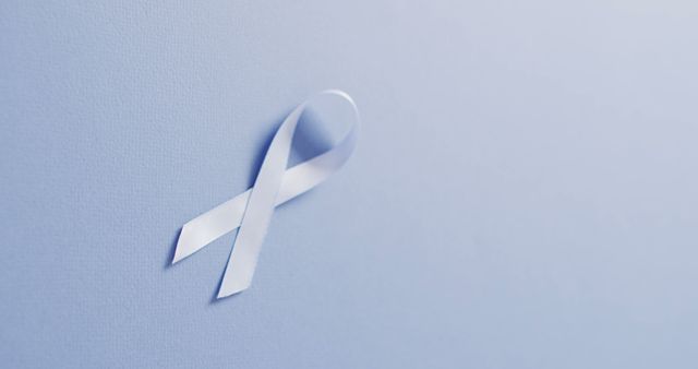 Image of pale blue prostate cancer ribbon on pale blue background. medical and healthcare awareness support campaign symbol for prostate cancer.