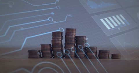 Stacks of coins with digital circuit overlay representing financial growth and fintech data