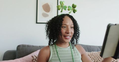 African american woman celebrating st patrick's day virtually wearing shamrock headband