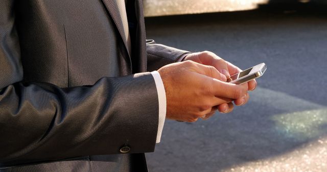 Businessman in Suit Texting on Smartphone Outdoors - Download Free Stock Images Pikwizard.com