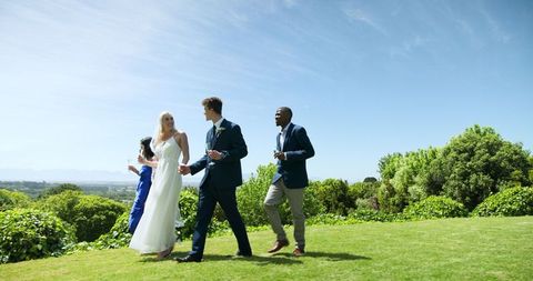 Bride and Groom Celebrating with Friends Outdoors
