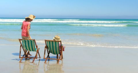 Senior Couple Relaxing in Deckchairs on Sunny Beach Day - Download Free Stock Images Pikwizard.com
