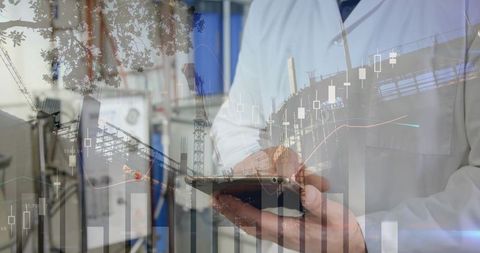 A visually striking double exposure showing a businessman using a tablet integrated with graphs and statistics overlay signifying technology in business analytics. Best suited for business process overviews, financial presentations, or technology company brochures. Symbolizes the merging of digital solutions with real-world business challenges.
