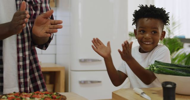 Excited Child Clapping Hands in Modern Kitchen - Download Free Stock Images Pikwizard.com