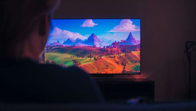 Woman Enjoying Leisure Time Watching TV Sit on Sofa at Home