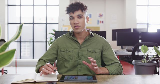 Young Professional Using Tablet and Notebook in Modern Office - Download Free Stock Images Pikwizard.com