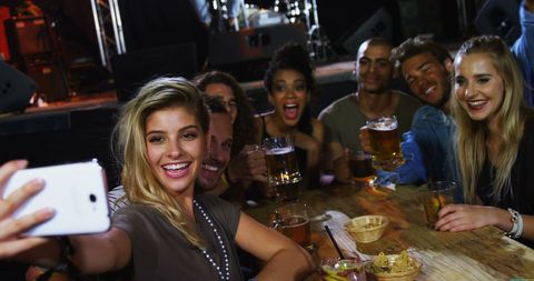 Diverse Friends Celebrating with Selfie at Bar