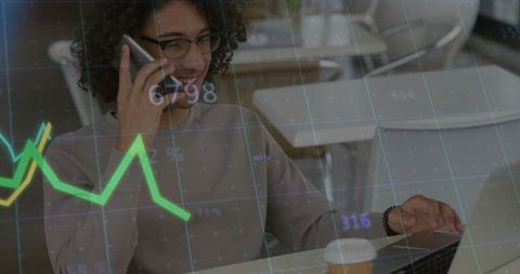 Business Professional Analyzing Data on Laptop with Smartphone