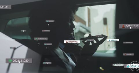 African american woman using phone with social notifications in car