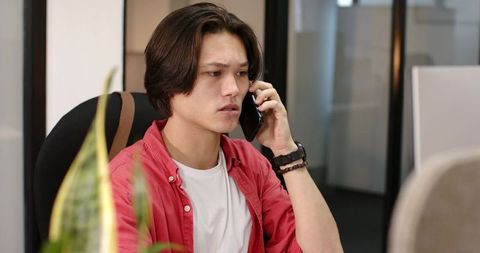 Young Professional Man on Phone in Open-Plan Office Environment