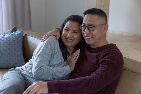 Happy Diverse Senior Couple Relaxing on Sofa