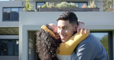 Joyful Embrace of Diverse Couple at Contemporary Home