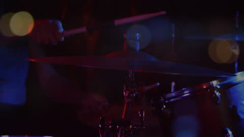 Nighttime Drum Performance with Bokeh Effect