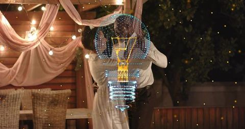 Romantic backyard dance with holographic light bulb projection and glowing string lights