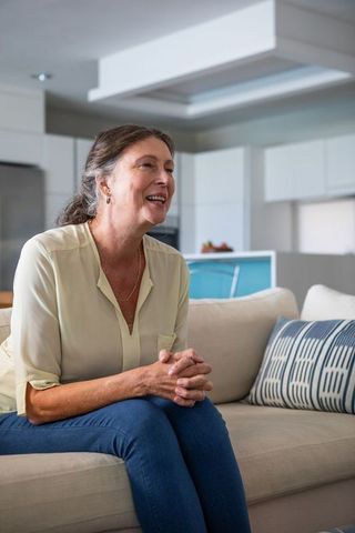 Senior Woman Happily Engaging in Relaxed Conversation at Home