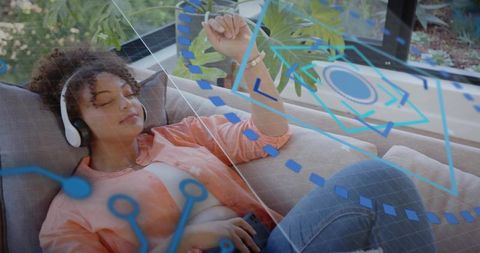 Young woman relaxing with headphones and smartphone on sofa amid augmented reality overlay