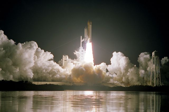 STS103-S-005 (19 December 1999) --- The Space Shuttle Discovery rises into the clear night sky to begin the 96th mission in the STS program.   Liftoff occurred at 7:50 p.m. (EST), December 19, 1999, from Launch Pad 39B.  Onboard were astronauts Curtis L. Brown, Jr., Scott J. Kelly, Steven L. Smith, C. Michael Foale, John M. Grunsfeld, Claude Nicollier and Jean-Francois Clervoy. Switzerland's Nicollier and France's Clervoy represent the European Space Agency (ESA).