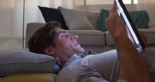 Man Lying on Floor Using Digital Tablet at Home - Download Free Stock Images Pikwizard.com