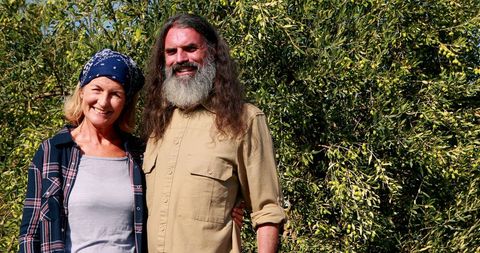 Happy Middle-aged Couple Embracing Nature in Sunshine