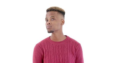Thoughtful african american man in red sweater against white background
