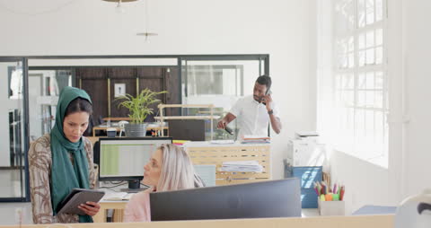 Diverse Office Team Collaborating on Project with Technology