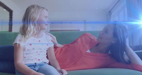 Mother and Daughter Sharing Special Moment on Green Couch
