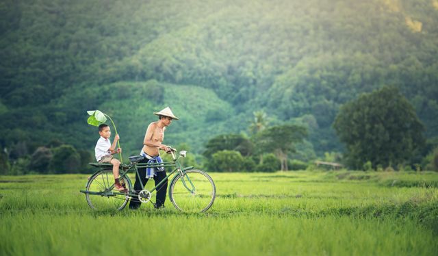 Friends Sitting on Bicycle Against Green Landscape - Download Free Stock Photos Pikwizard.com