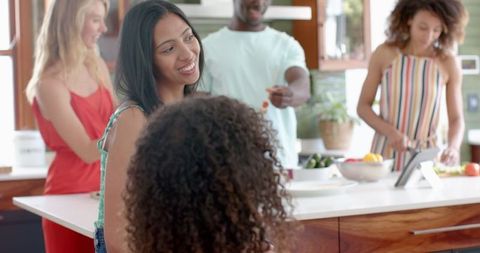 Diverse Family Enjoys Time Together Preparing Meal In Modern Kitchen