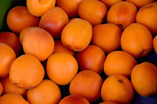 Close-Up of Fresh Apricots Displayed at a Market - Download Free Stock Photos Pikwizard.com