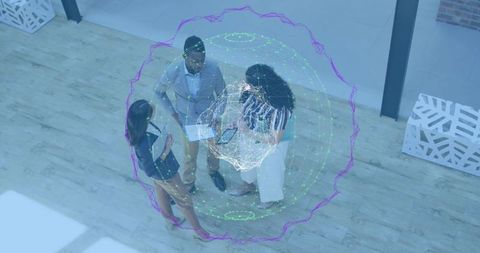 Business Team Standing Under Holographic Network Discussing Digital Strategy in Atrium