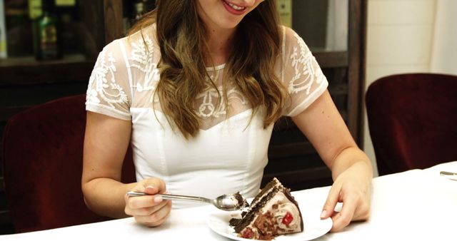 Business woman eating a chocolate cake in a restaurant - Download Free Stock Photos Pikwizard.com
