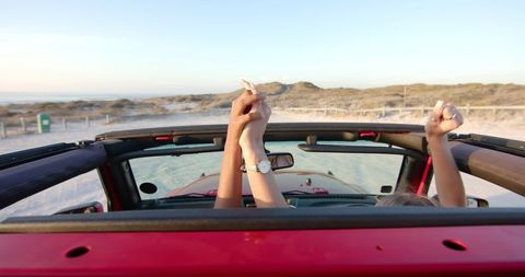 Joyful Beach Road Trip Adventure in Red Convertible