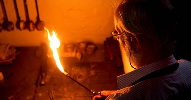 Senior Craftsperson Working with Open Flame in Workshop - Download Free Stock Images Pikwizard.com