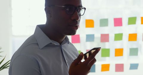 Businessman Using Smartphone Voice Command in Office