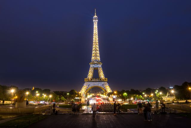 Eiffel Tower Illuminated at Night with Tourists - Download Free Stock Photos Pikwizard.com