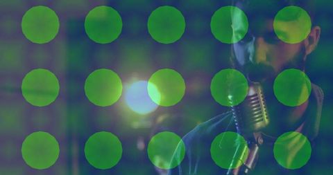 Bearded singer crooning in relaxed music studio with green shine