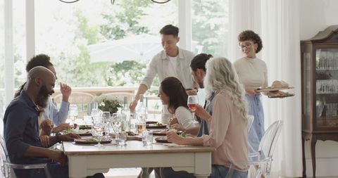 Close-knit family enjoying meal gathering in bright dining room
