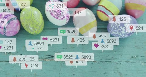 Decorated pastel easter eggs sitting on worn turquoise wood with social media notifications