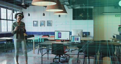 Woman with Tablet Analyzing Data in Modern Workspace