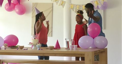 Family Celebrating Birthday with Decorations and Cake
