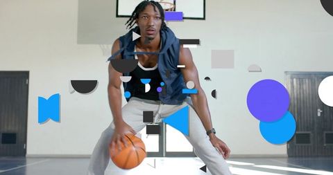 Explosive basketball dribbling athlete lowering stance driving toward hoop with ball