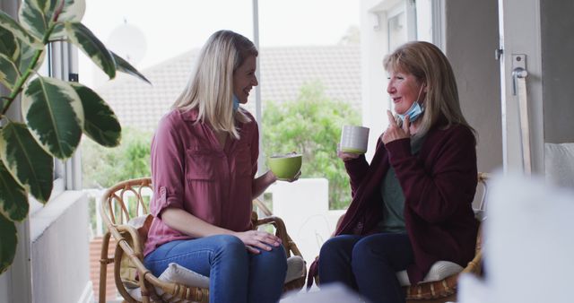 Two Women Enjoying Coffee and Conversation at Bright Home - Download Free Stock Photos Pikwizard.com