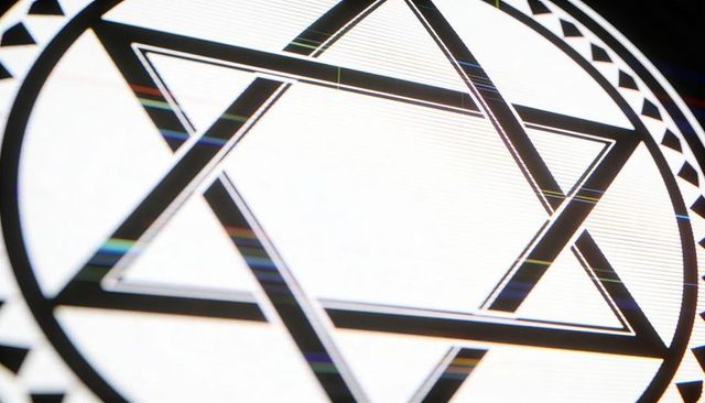 Displaying black hexagram in circular border with backlit scan lines and rainbow glitches