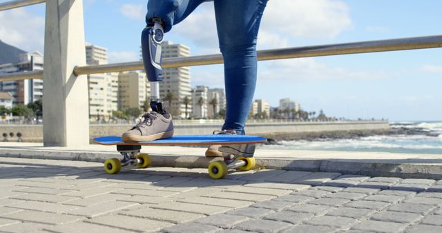 Person with Prosthesis Preparing to Skateboard by Coastal Boardwalk - Download Free Stock Images Pikwizard.com