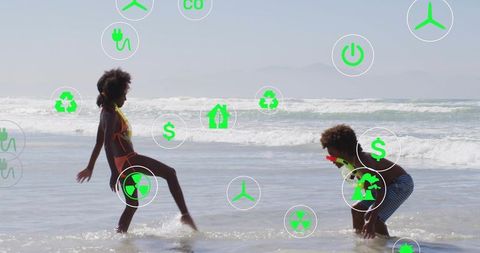 Children playing and splashing on sunlit beach wearing snorkel gear with green eco icons overlay