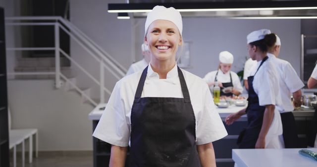 Confident Female Chef Smiling in Commercial Kitchen - Download Free Stock Images Pikwizard.com